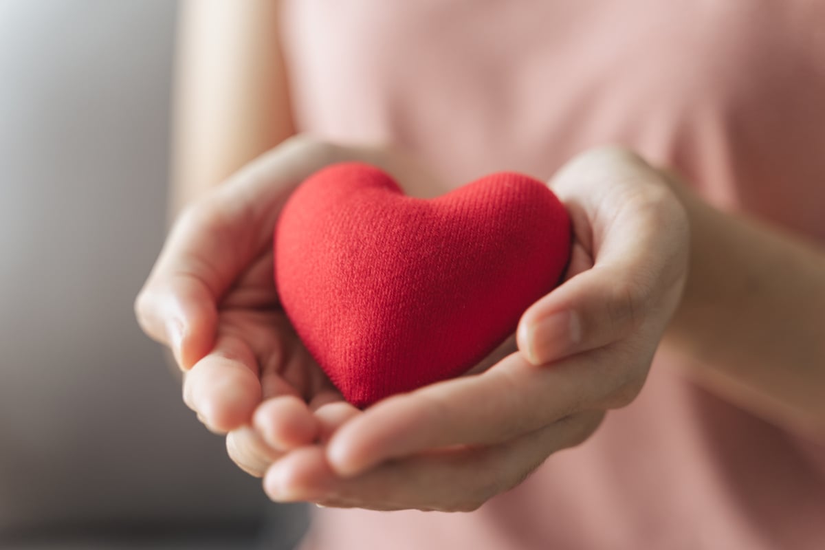 Woman holding red heart, love, health insurance, donation, happy charity volunteer, world mental health day, world heart day, valentine's day